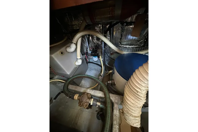 Slide: The Image of Engine room of 1985 Carver 3207 Aft Cabin Motor Yacht with hoses and components. - 29