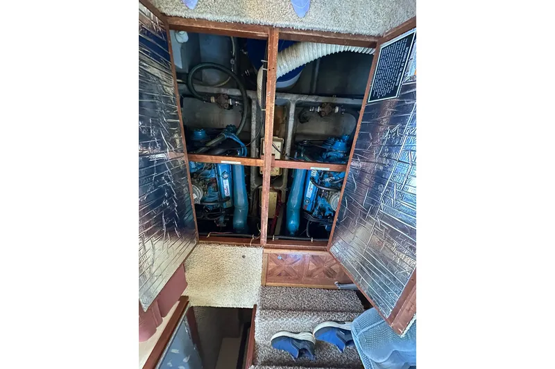 Slide: The Image of Engine compartment of 1985 Carver 3207 Aft Cabin Motor Yacht, showcasing dual engines. - 30