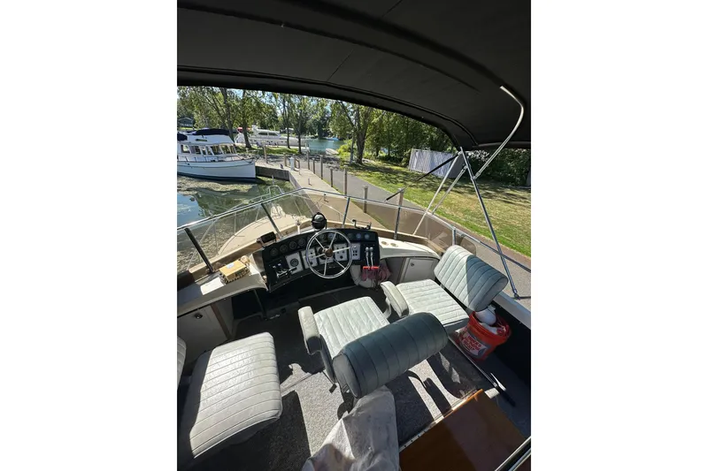 Slide: The Image of Interior view of 1985 Carver 3207 Aft Cabin Motor Yacht cockpit with seating and controls. - 34