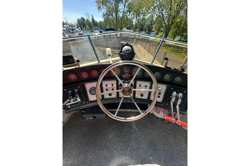 Slide: The Image of Helm of 1985 Carver 3207 Aft Cabin Motor Yacht with steering wheel and control panel. - 35