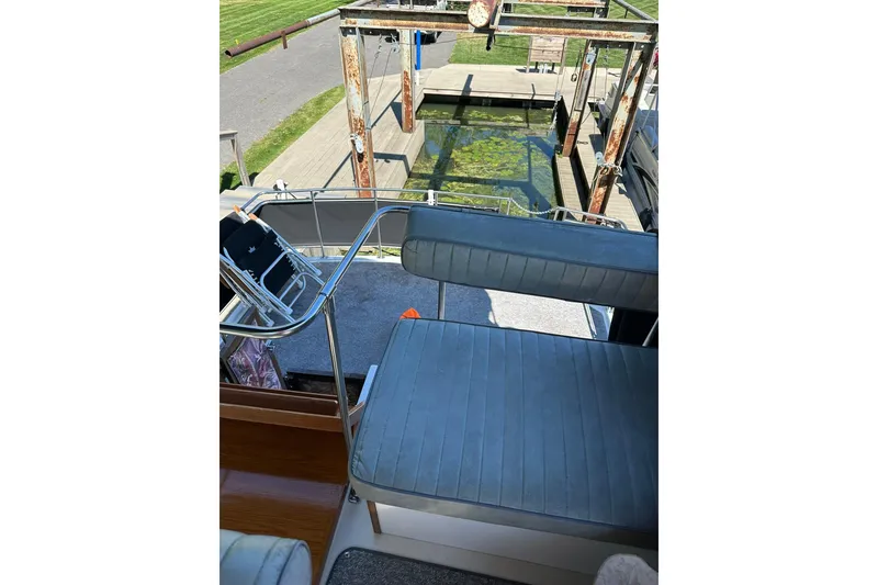 Slide: The Image of 1985 Carver 3207 Aft Cabin Motor Yacht interior with seating and dock view. - 38