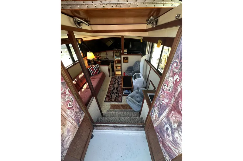 Slide: The Image of Interior of 1985 Carver 3207 Aft Cabin Motor Yacht, featuring cozy seating and decor. - 7