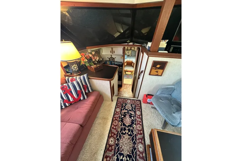 Slide: The Image of Interior of 1985 Carver 3207 Aft Cabin Motor Yacht with cozy seating and nautical decor. - 8