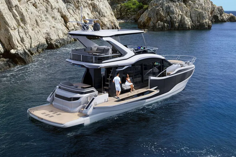 Slide: The Image of Manufacturer Provided Image: 2026 Galeon 520 Fly yacht cruising near rocky coastline, featuring modern design and spacious deck. - 1