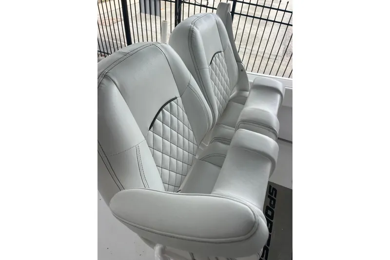Slide: The Image of 2024 Sportsman Open 212 Center Console boat seats with quilted design and armrests. - 12