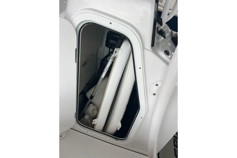 Slide: The Image of 2024 Sportsman Open 212 Center Console storage compartment with equipment and supplies. - 15