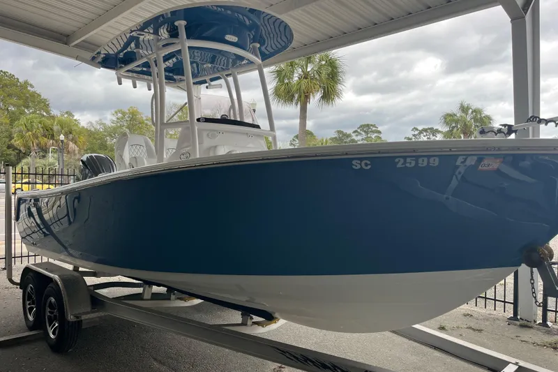 Slide: The Image of 2024 Sportsman Open 212 Center Console boat on trailer under shelter. - 5