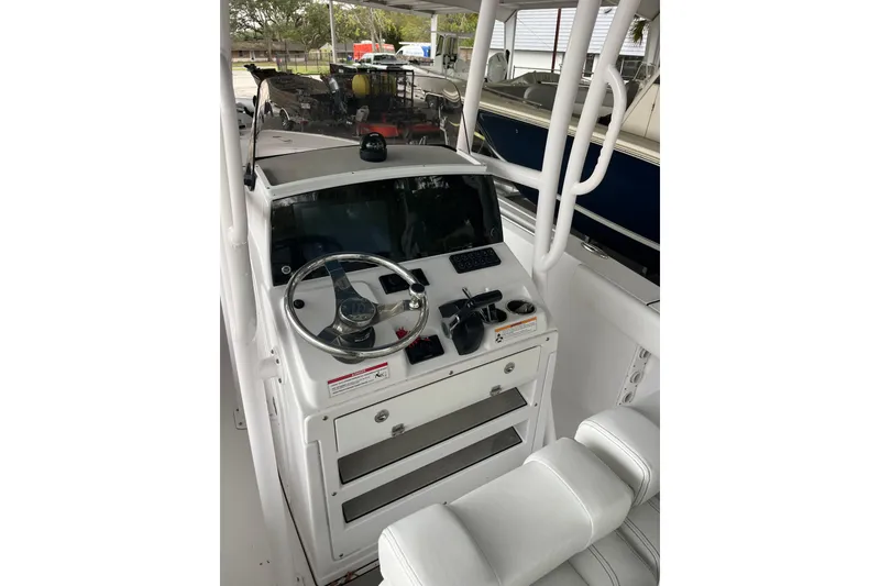 Slide: The Image of 2024 Sportsman Open 212 Center Console boat interior with steering wheel and controls. - 7