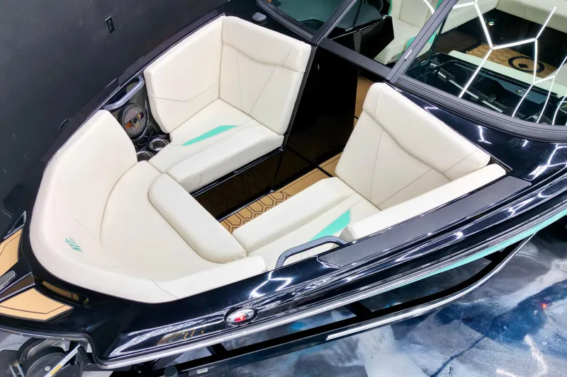 Slide: The Image of 2024 MasterCraft NXT21 boat interior with white seating and modern design. - 13