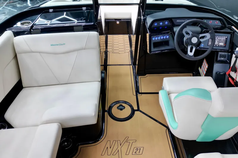 Slide: The Image of 2024 MasterCraft NXT21 boat interior with modern dashboard and comfortable seating. - 16