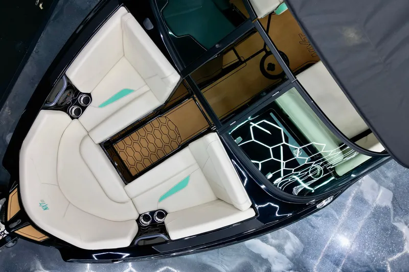 Slide: The Image of 2024 MasterCraft NXT21 boat interior with sleek white seating and modern design elements. - 6