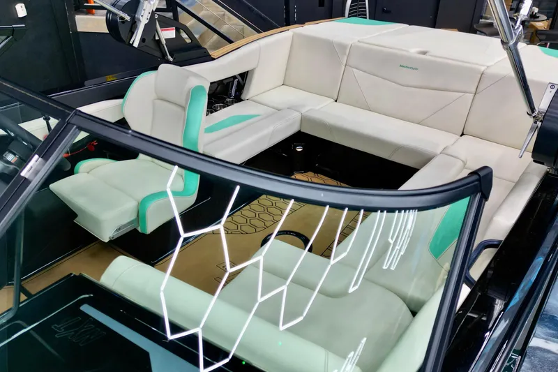 Slide: The Image of 2024 MasterCraft NXT21 boat interior with white and teal seating, modern design. - 7