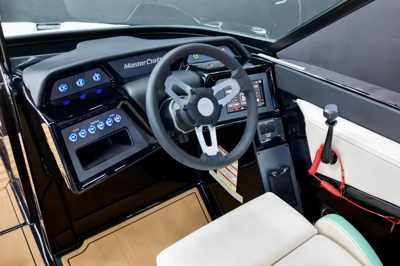 Slide: The Image of 2024 MasterCraft NXT21 boat dashboard with modern controls and steering wheel. - 9