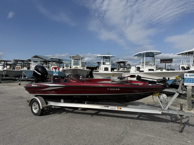 The Image of 2009 Triton Explorer 18 on trailer at boat sale. - 1