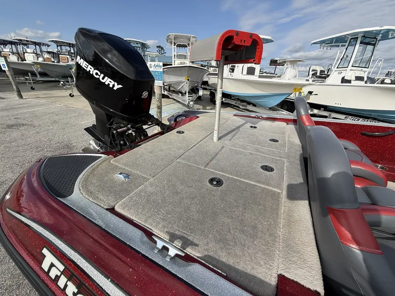 Slide: The Image of 2009 Triton Explorer 18 boat with Mercury engine on parking lot. - 6