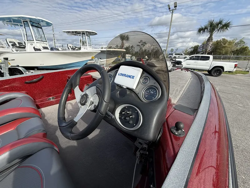 Slide: The Image of 2009 Triton Explorer 18 boat cockpit with steering wheel and instruments. - 7