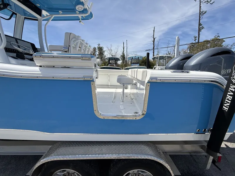 Slide: The Image of 2021 Sea Hunt Gamefish 25 boat with blue exterior and dual engines. - 5