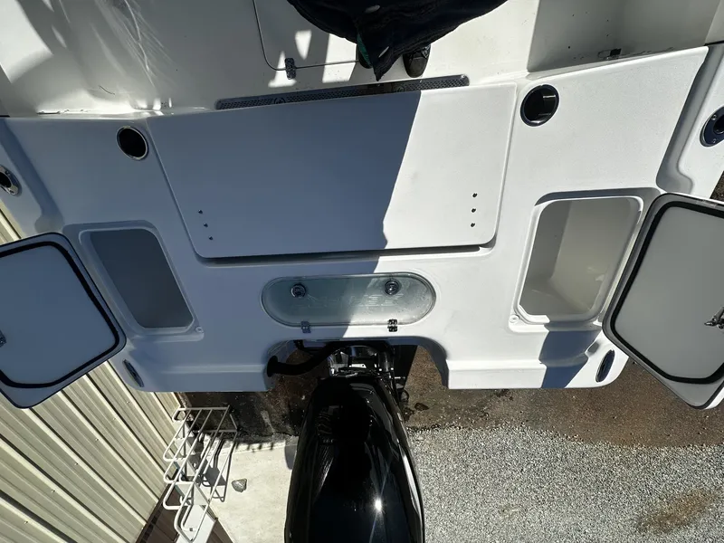 Slide: The Image of Sea Pro 250 Bay 2026 boat deck with storage compartments and motor. - 8