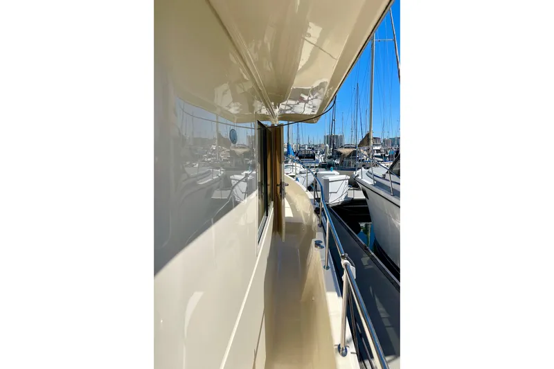 Slide: The Image of 2008 Mainship 34 Trawler side deck view in marina setting. - 13