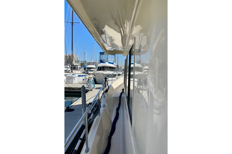 Slide: The Image of 2008 Mainship 34 Trawler docked at marina, side view with clear blue sky. - 14