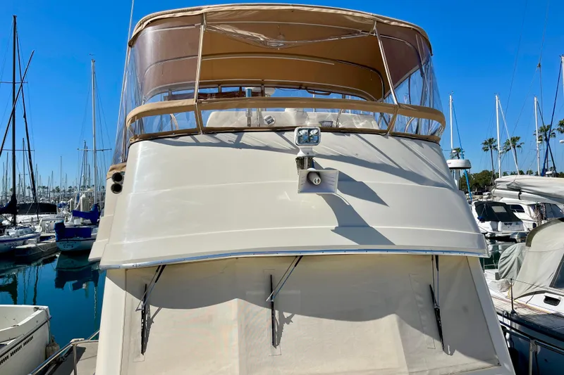 Slide: The Image of 2008 Mainship 34 Trawler docked in a marina under clear blue skies. - 20