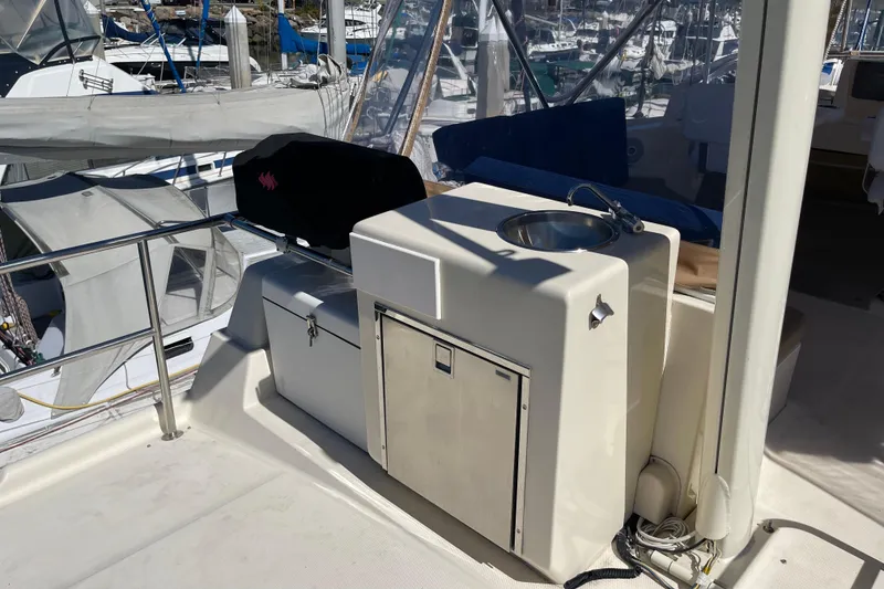 Slide: The Image of 2008 Mainship 34 Trawler deck with sink and storage, docked at marina. - 25