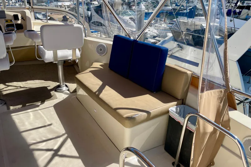 Slide: The Image of 2008 Mainship 34 Trawler interior with seating and helm, docked at marina. - 28