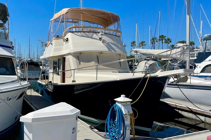 Slide: The Image of 2008 Mainship 34 Trawler docked at marina under clear blue sky. - 3