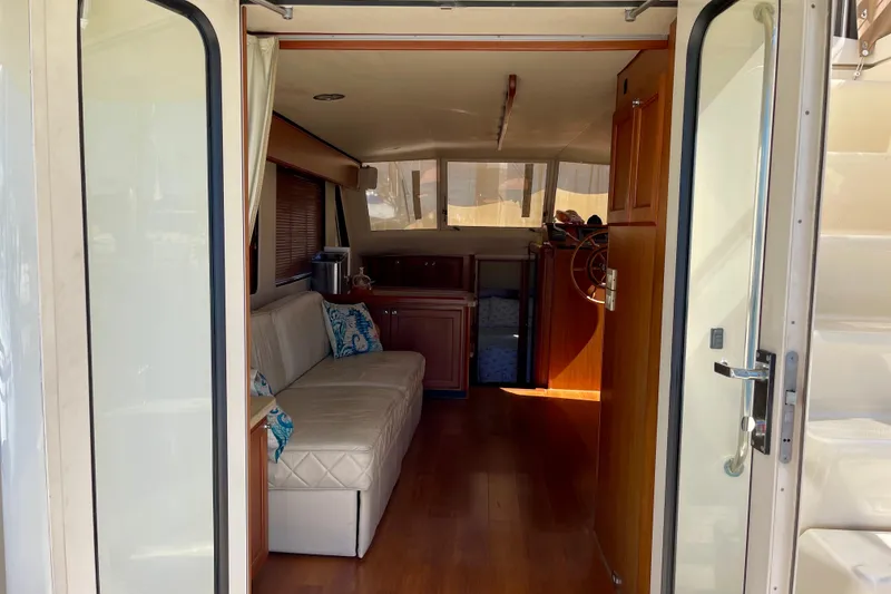 Slide: The Image of Interior view of 2008 Mainship 34 Trawler with cozy seating and wooden finishes. - 33