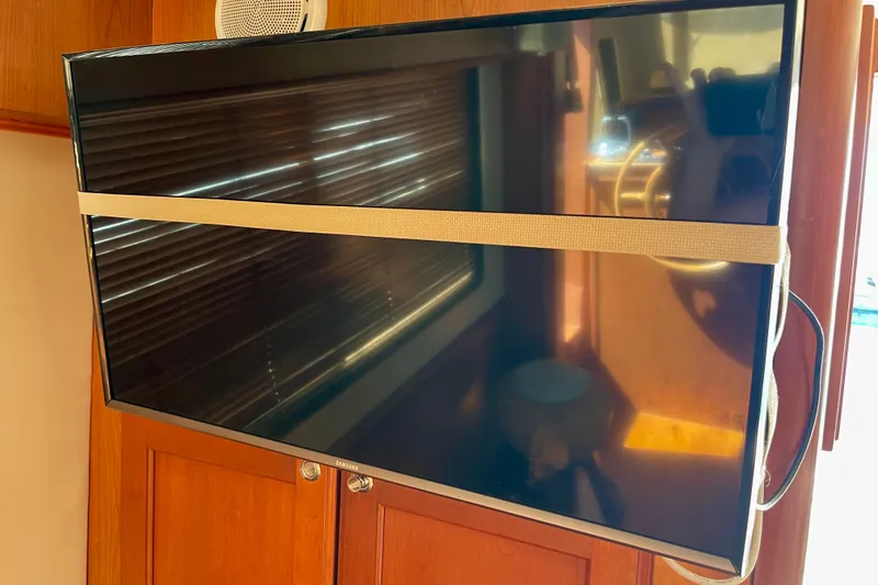 Slide: The Image of Flat-screen TV secured with a strap inside a 2008 Mainship 34 Trawler boat. - 43