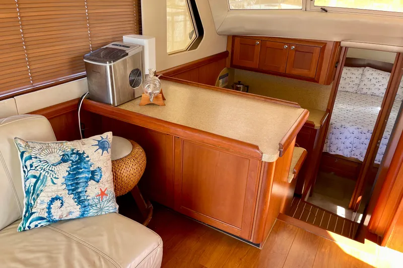 Slide: The Image of Interior of 2008 Mainship 34 Trawler with wooden cabinetry and nautical-themed decor. - 44