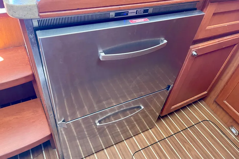 Slide: The Image of Stainless steel refrigerator in 2008 Mainship 34 Trawler kitchen with wood cabinetry. - 46