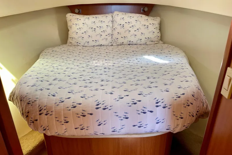 Slide: The Image of Cozy cabin bed in 2008 Mainship 34 Trawler with patterned bedding. - 51