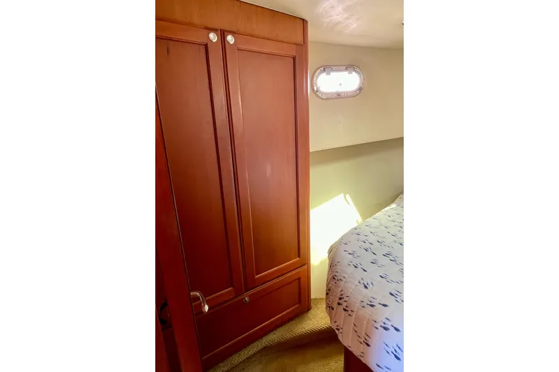 Slide: The Image of Interior cabin of 2008 Mainship 34 Trawler with wooden closet and bed. - 52