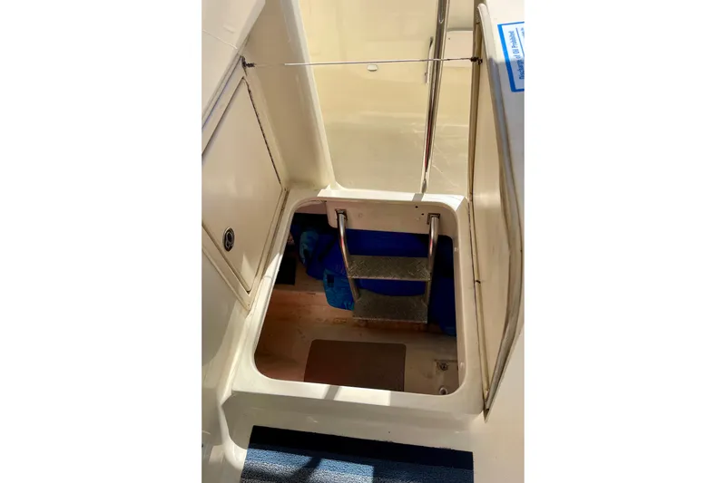 Slide: The Image of 2008 Mainship 34 Trawler interior hatch with steps and storage area. - 57