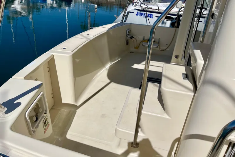 Slide: The Image of 2008 Mainship 34 Trawler deck with seating and railing, docked at marina. - 7