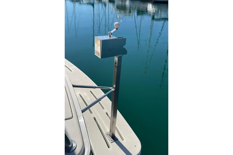 Slide: The Image of 2008 Mainship 34 Trawler stern view with metal pole and calm water reflection. - 8