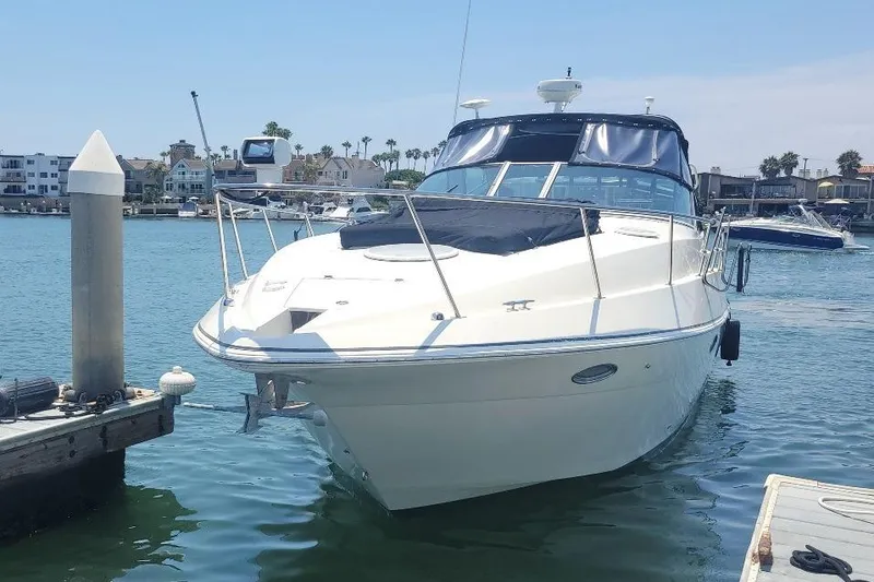 Slide: The Image of 2005 Cruisers Yachts 340 Express docked in a marina under clear skies. - 1
