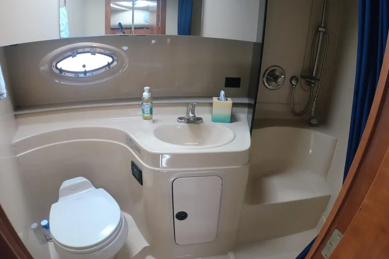 Slide: The Image of Bathroom interior of 2005 Cruisers Yachts 340 Express with sink, toilet, and shower. - 13