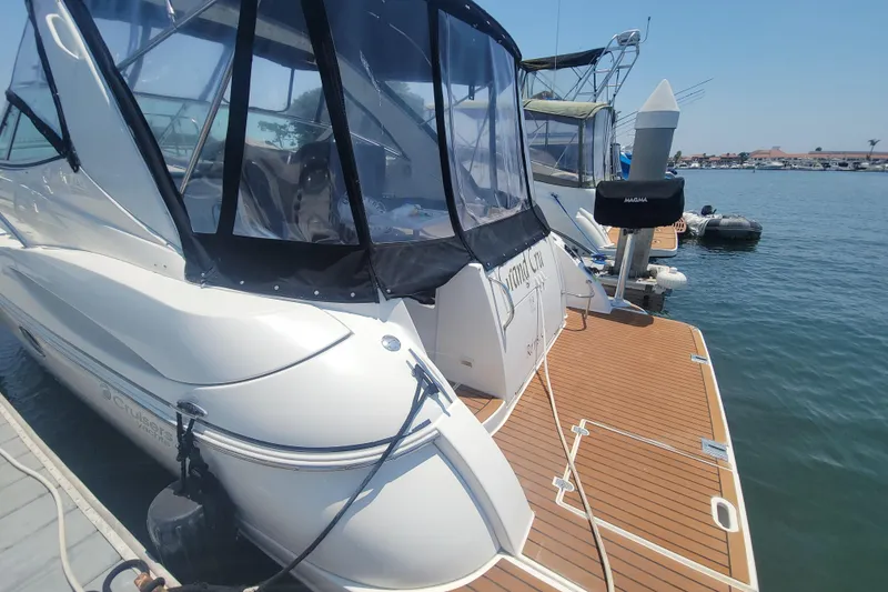 Slide: The Image of 2005 Cruisers Yachts 340 Express docked, featuring sleek design and spacious deck. - 15