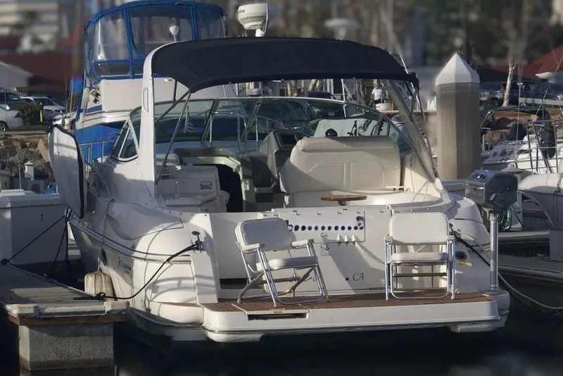 Slide: The Image of 2005 Cruisers Yachts 340 Express docked at marina, rear view with seating area. - 20