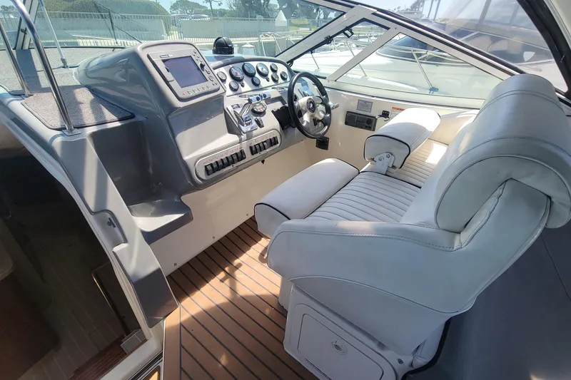 Slide: The Image of 2005 Cruisers Yachts 340 Express helm with modern controls and comfortable seating. - 3