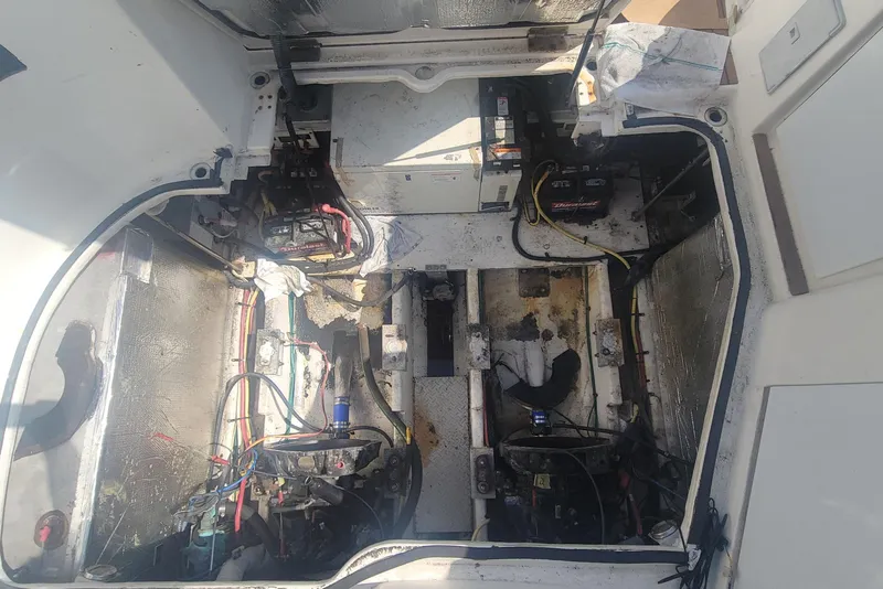 Slide: The Image of Engine compartment of a 2005 Cruisers Yachts 340 Express, showing wiring and battery setup. - 6