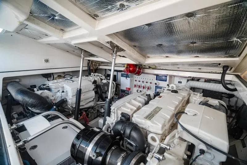Slide: The Image of Engine room of 2005 Cabo 35 Express boat, showcasing dual engines and control systems. - 31