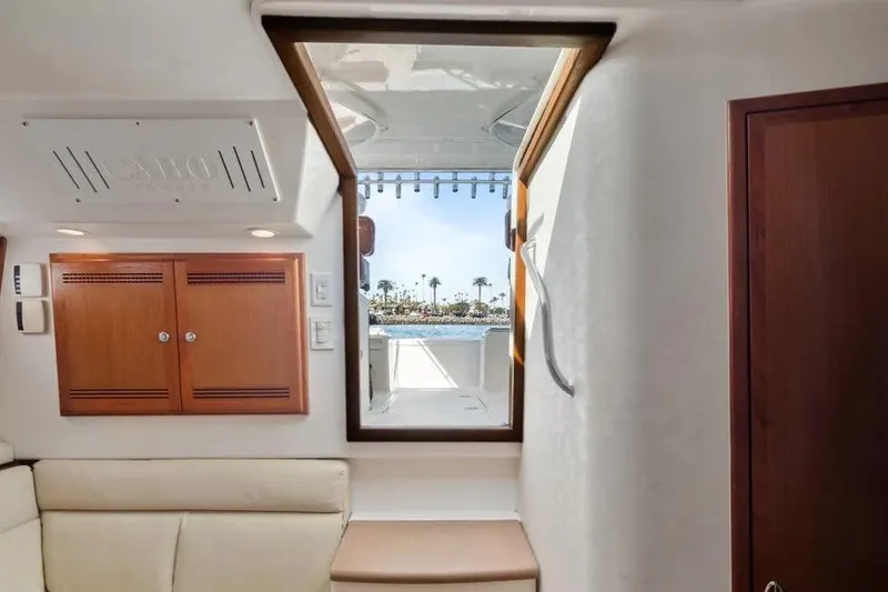 Slide: The Image of Interior view of 2005 Cabo 35 Express yacht with open hatch and ocean view. - 32