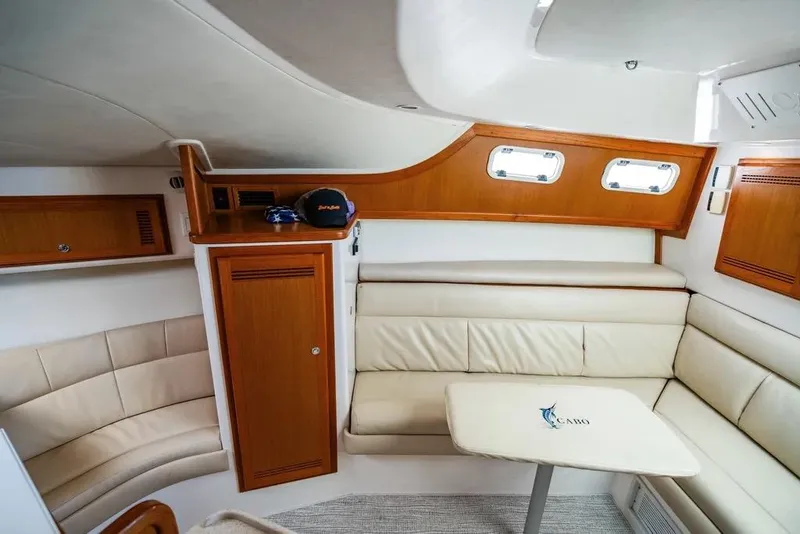 Slide: The Image of Luxurious interior of 2005 Cabo 35 Express yacht with leather seating and wooden accents. - 34