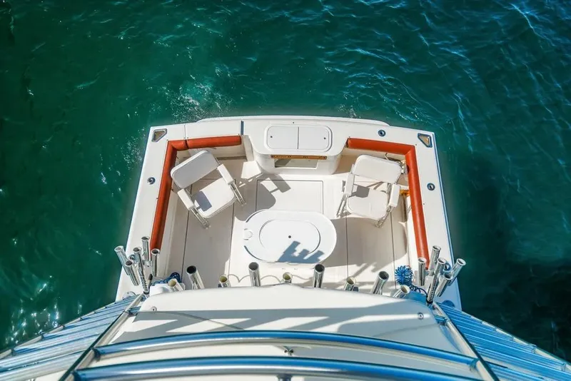 Slide: The Image of Aerial view of 2005 Cabo 35 Express boat deck on clear blue water. - 37