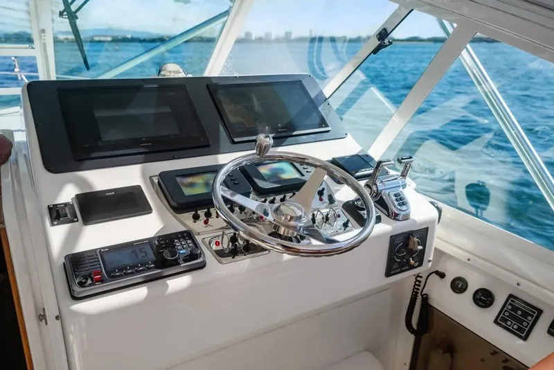 Slide: The Image of Helm of 2005 Cabo 35 Express boat with modern navigation equipment and steering wheel. - 47