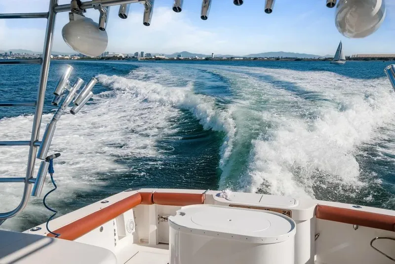Slide: The Image of 2005 Cabo 35 Express boat cruising on open water, leaving a wake behind. - 50