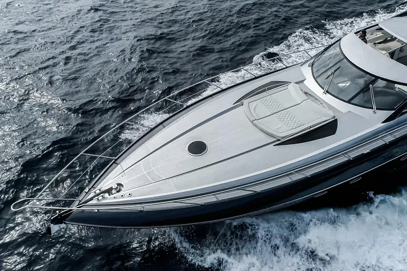 Slide: The Image of 2021 Sunseeker Predator 68 yacht cruising on open water, aerial view. - 2